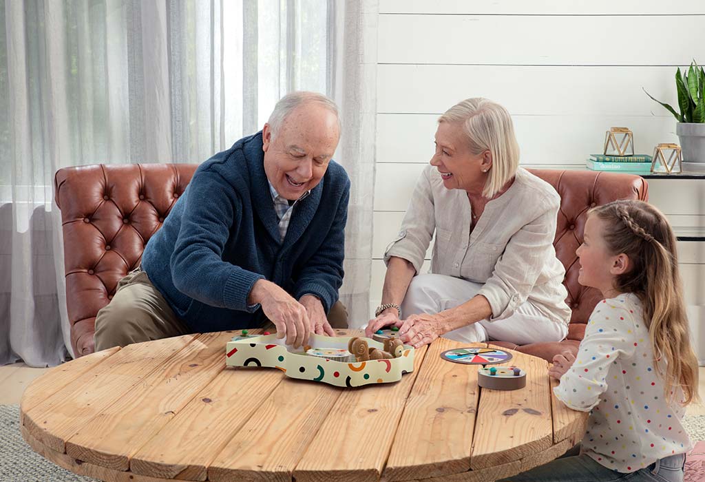 Grandfather and granddaughter at table